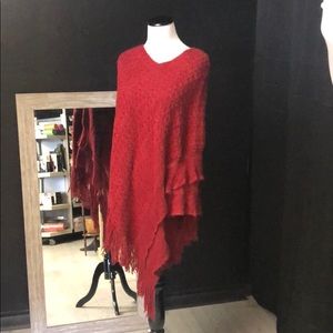 Red acrylic pullover poncho with tassel fringe